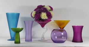 a selection of coloured flower vases